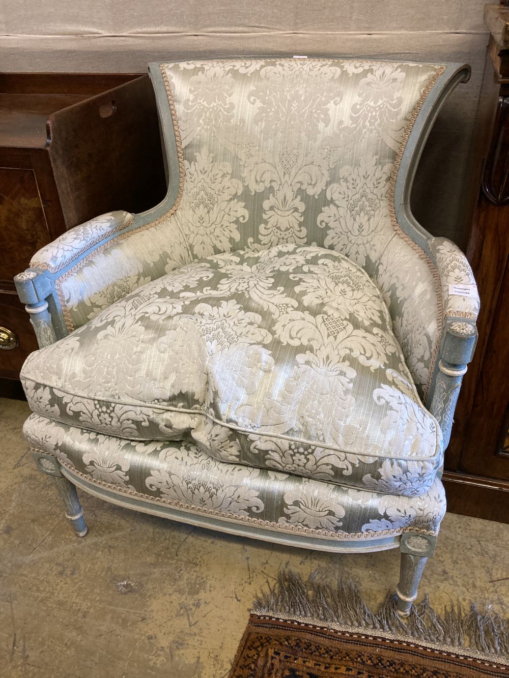 A Louis XV style grey and cream painted carved wood fauteuil, width 75cm, height 86cm